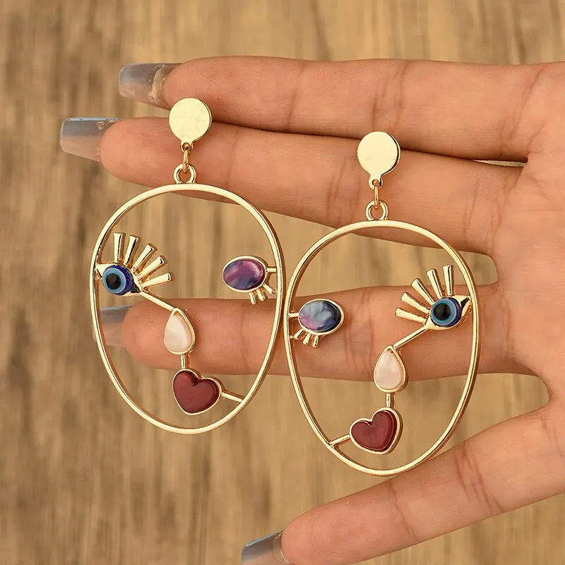 Boucles d’oreilles pendantes visage abstrait