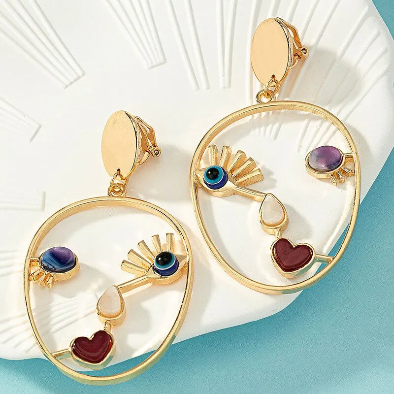 Boucles d’oreilles pendantes visage abstrait
