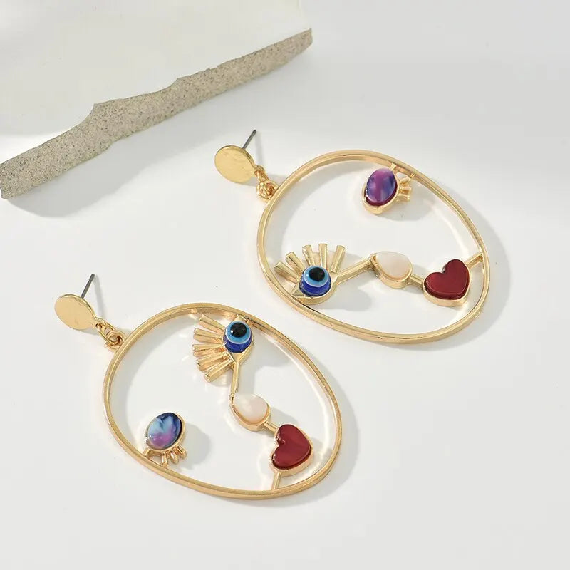 Boucles d’oreilles pendantes visage abstrait